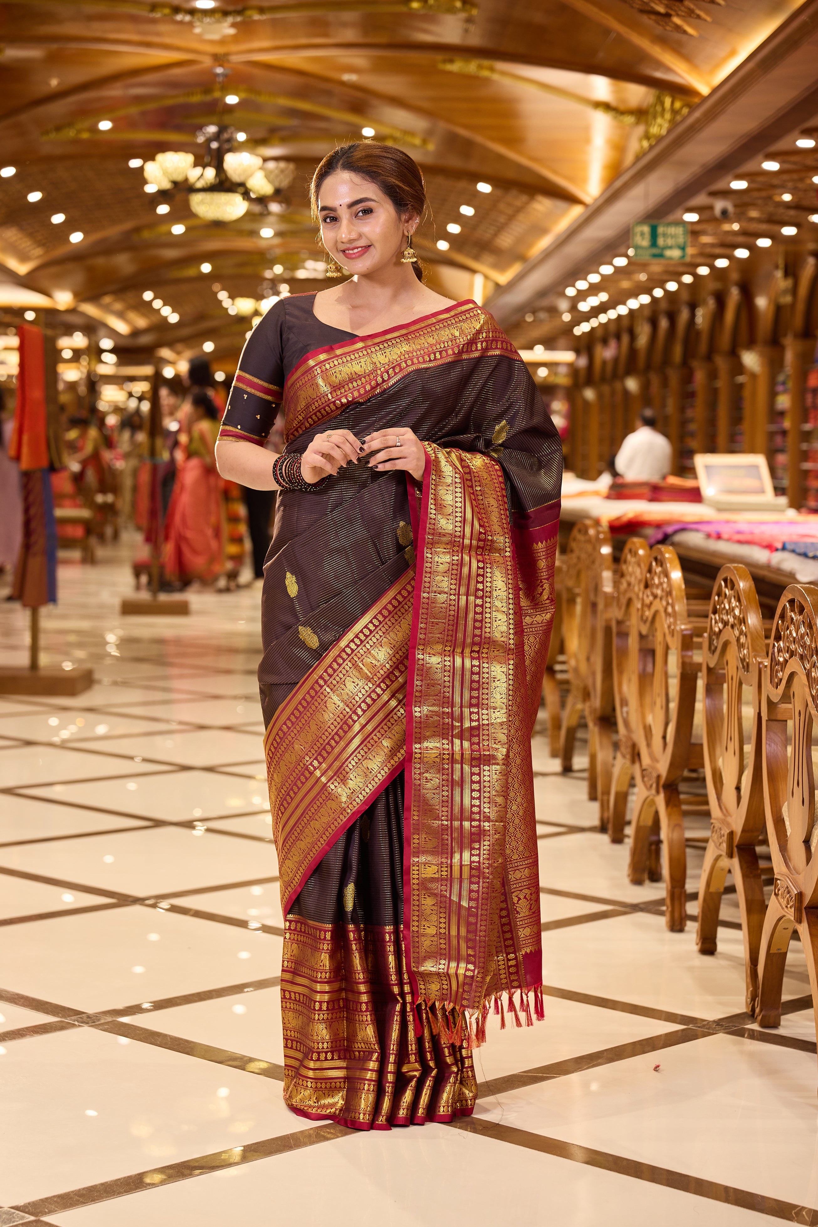 Dark Brown Kanchipuram Silk saree with traditional Vaira Oosi lines and peacock motif weaving, contrast Maroon and Gold Zari traditional long border and pallu, paired with matching blouse piece.