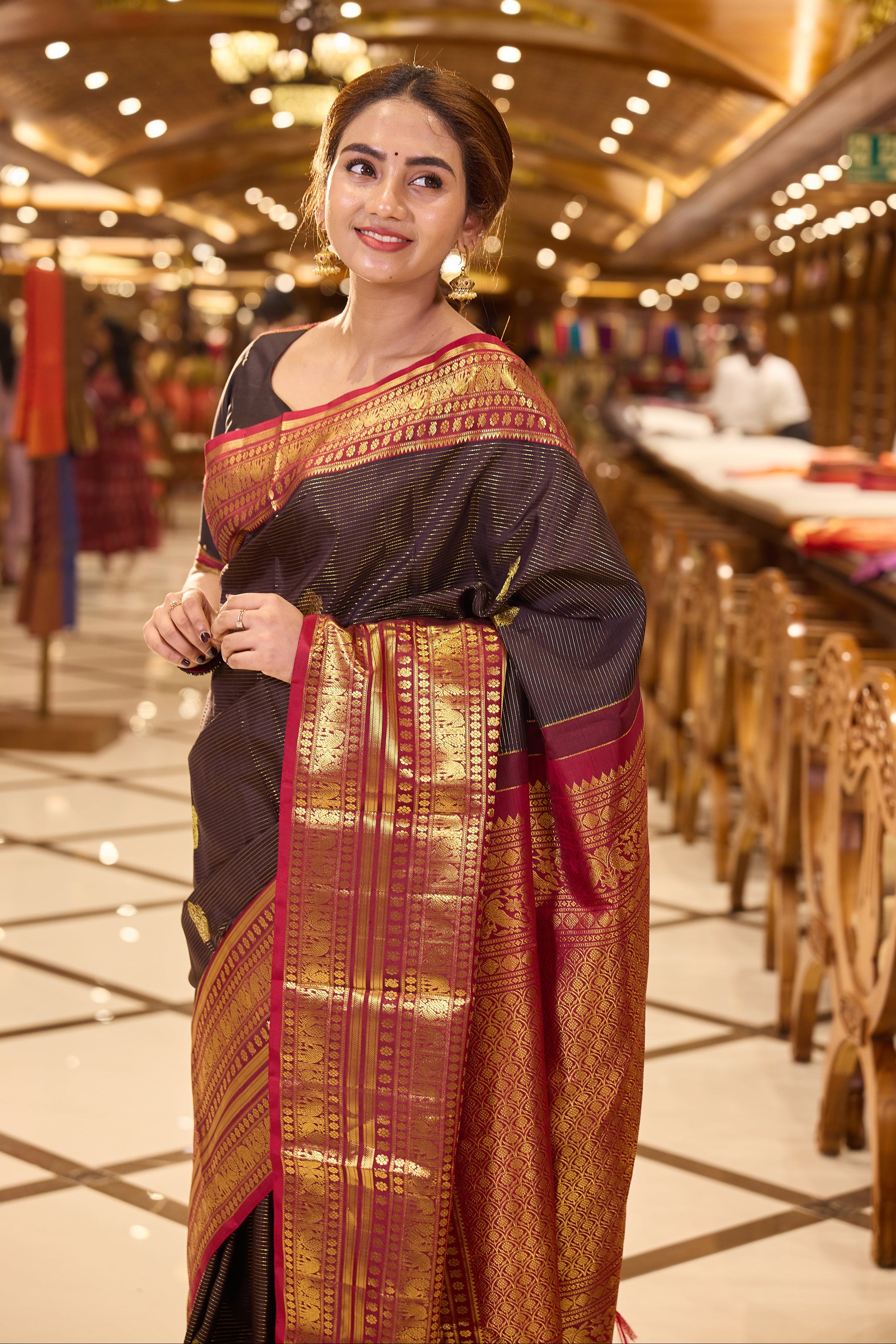 Dark Brown Kanchipuram Silk saree with traditional Vaira Oosi lines and peacock motif weaving, contrast Maroon and Gold Zari traditional long border and pallu, paired with matching blouse piece.