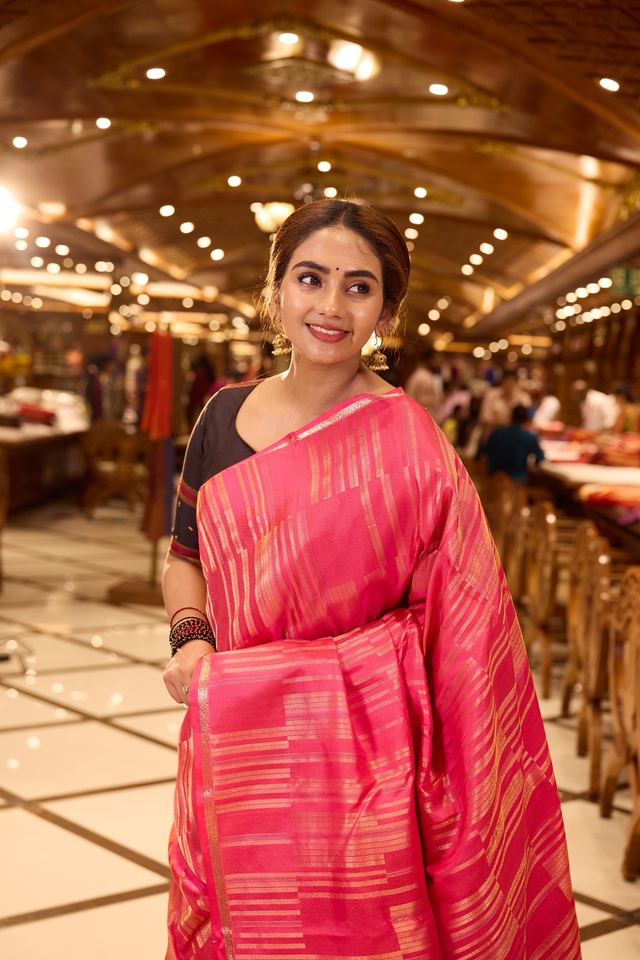 Plush Pink Kanchipuram Parampara Pattu saree featuring elegant diagonal geometric tissue zari line weaving with embossed silk patterns across the body, enhanced by a refined zari piping border and paired with a matching blouse piece.