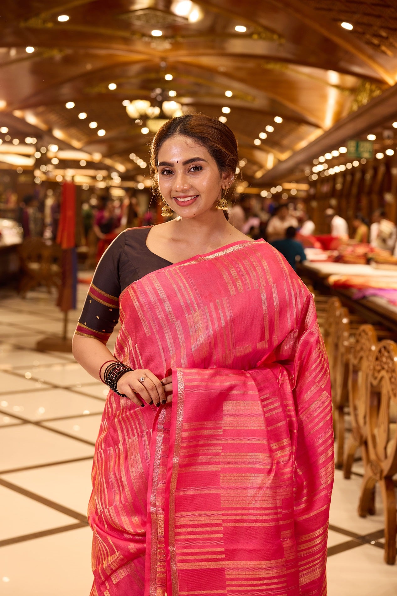 Plush Pink Kanchipuram Parampara Pattu saree featuring elegant diagonal geometric tissue zari line weaving with embossed silk patterns across the body, enhanced by a refined zari piping border and paired with a matching blouse piece.