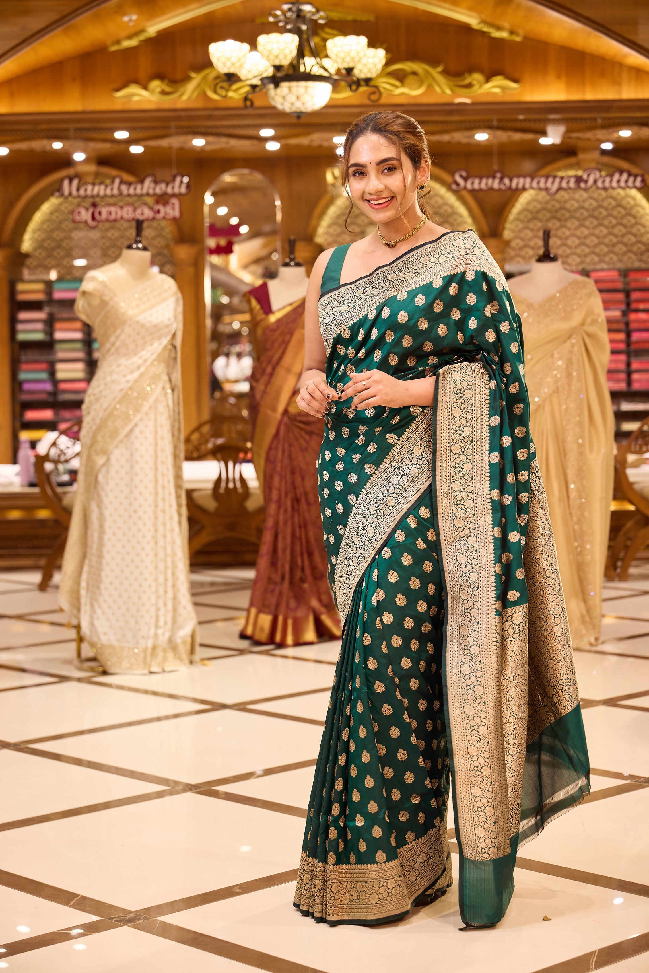 Ruby green colour pure Banaras Katan saree adorned with small motifs all over the body, featuring a traditional Banaras border and pallu, paired with a matching blouse.