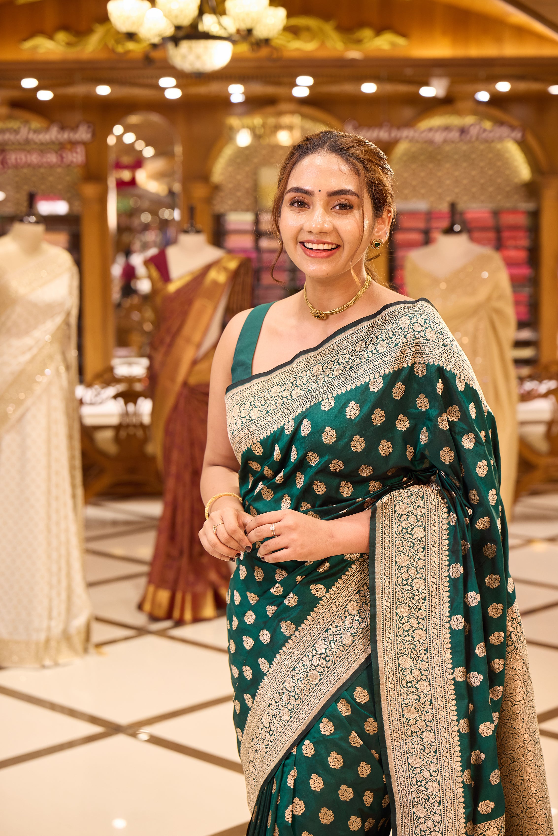 Ruby green colour pure Banaras Katan saree adorned with small motifs all over the body, featuring a traditional Banaras border and pallu, paired with a matching blouse.