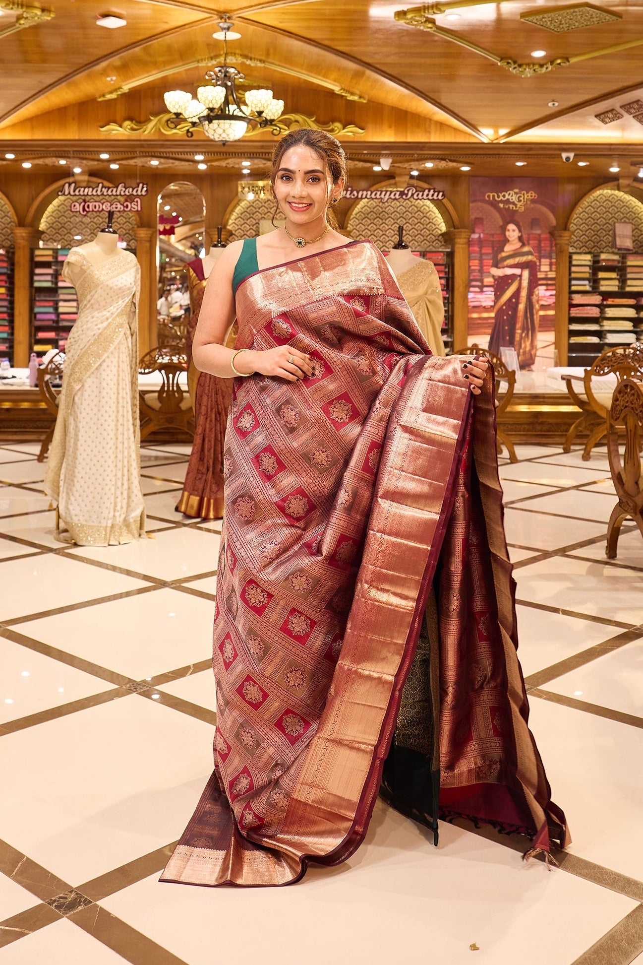 Wine Maroon Colour Kanchipuram Silk Saree with geometric box motif pattern, antique jari shimmer Meena Kari weaving, and traditional antique copper border. Paired with matching blouse piece.