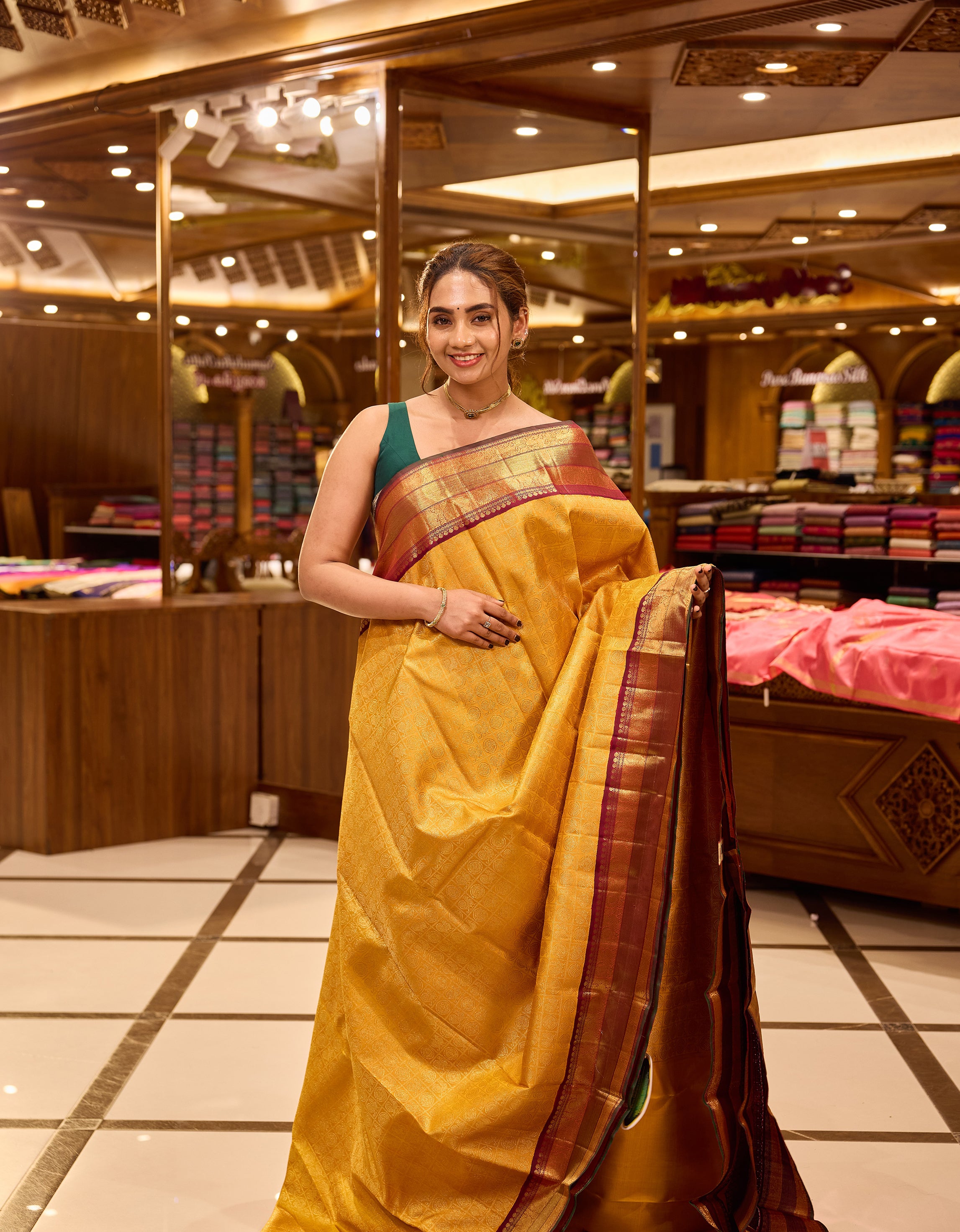Golden mustard and wine maroon contrast Kanchipuram Samudrika Pattu saree in pure zari jacquard, featuring 3-gram gold zari peacock and chakram checks design with rich contrast border, pallu, and matching blouse.