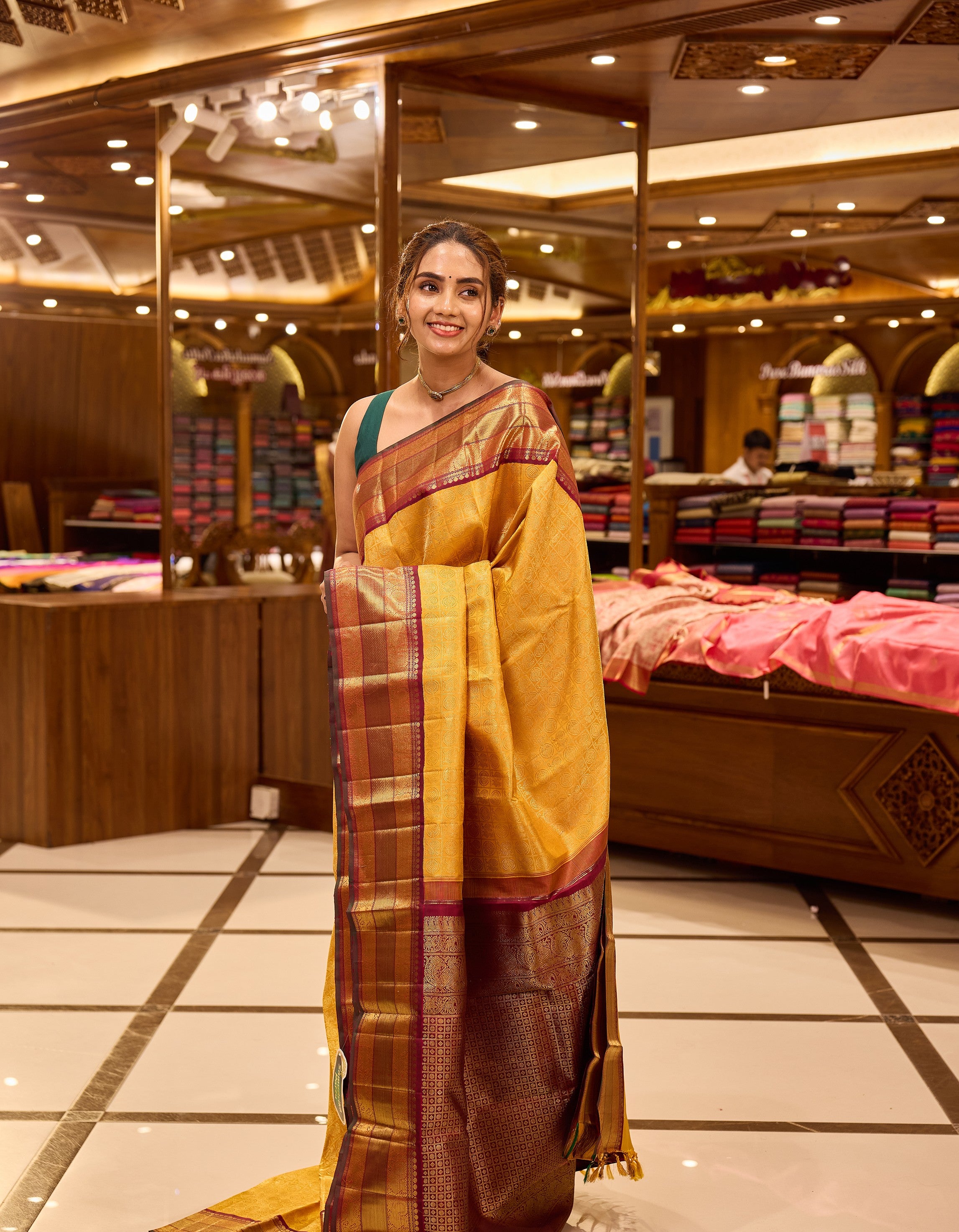 Golden mustard and wine maroon contrast Kanchipuram Samudrika Pattu saree in pure zari jacquard, featuring 3-gram gold zari peacock and chakram checks design with rich contrast border, pallu, and matching blouse.