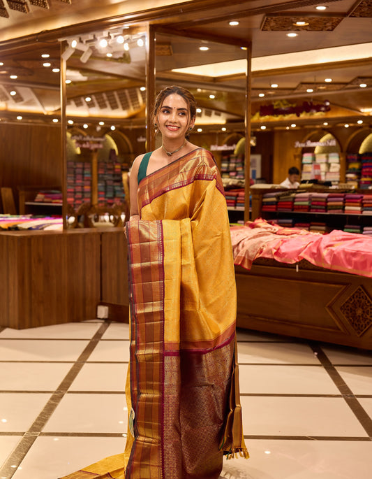 Golden mustard and wine maroon contrast Kanchipuram Samudrika Pattu saree in pure zari jacquard, featuring 3-gram gold zari peacock and chakram checks design with rich contrast border, pallu, and matching blouse.
