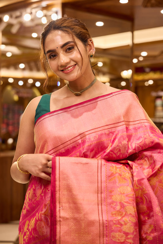 Pink colour pure Kancheepuram soft silk saree featuring floral motifs all over the body with a self colour border, complemented by a rich pallu and a matching silk blouse.