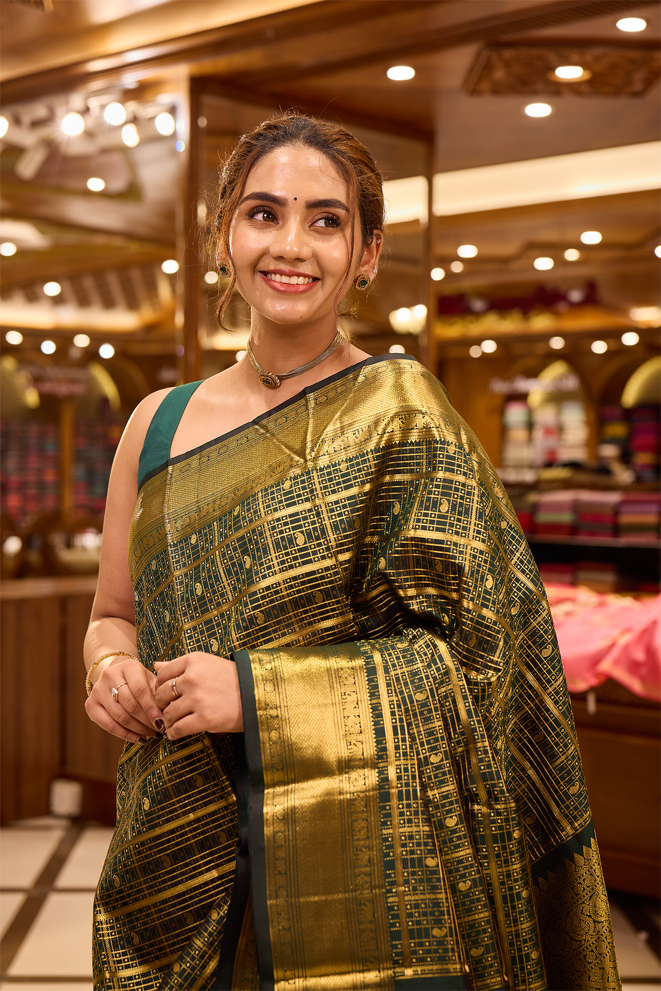 Bottle green colour pure Kancheepuram silk saree featuring gold zari checks all over the body with a gold zari border, complemented by a rich pallu and a matching silk blouse.