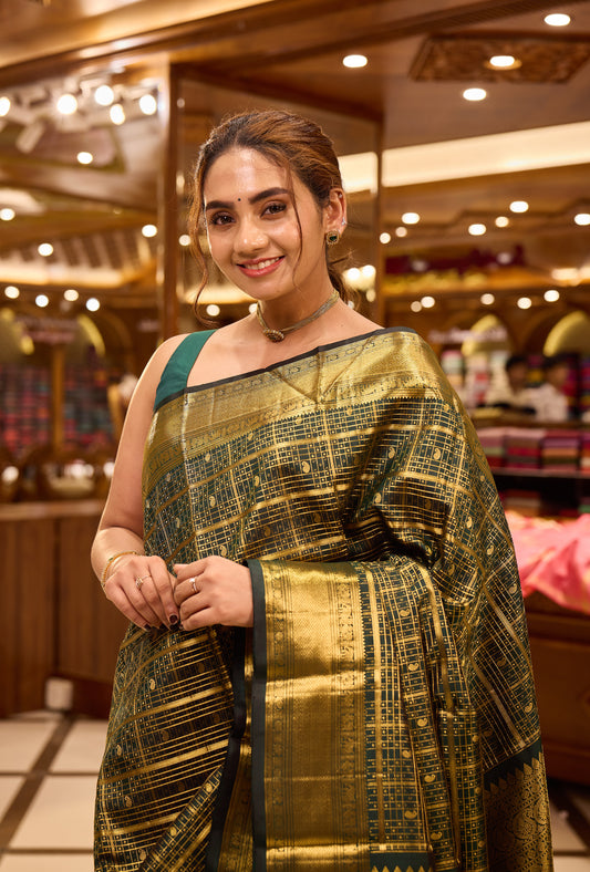Bottle green colour pure Kancheepuram silk saree featuring gold zari checks all over the body with a gold zari border, complemented by a rich pallu and a matching silk blouse.