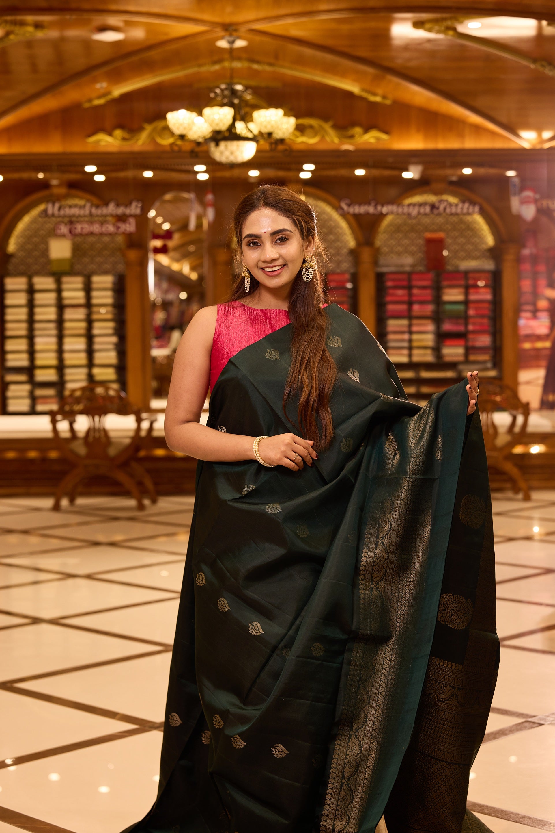 Bottle green pure Mayuri Soft silk saree adorned with elegant antique zari motifs across the body, featuring a traditional antique zari pallu and a refined one side border, gracefully paired with a matching blouse