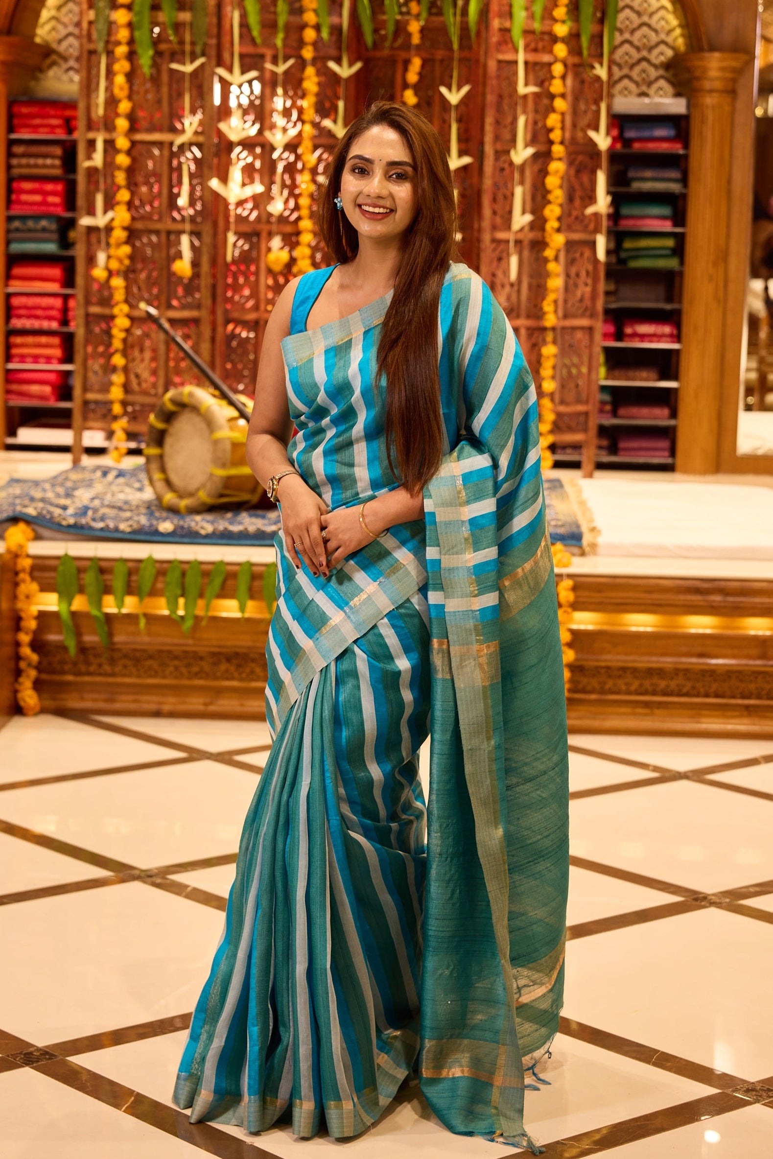 Refreshing blue pure Tussar silk saree featuring contemporary vertical and horizontal stripe patterns in lighter aqua tones, lending a youthful and elegant appeal, gracefully paired with a matching blouse