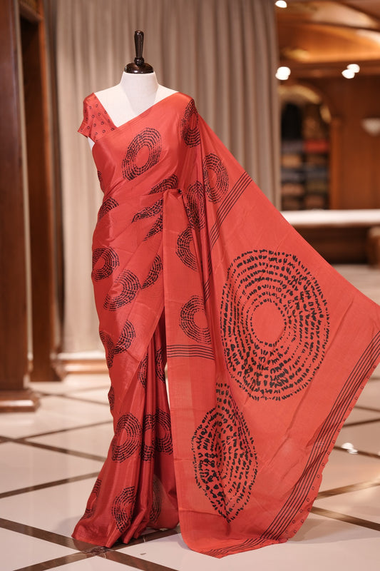 Red & Black colour Turkey crepe saree featuring elegant circle designs all over, with a large circular pattern on the pallu and delicate small circle motifs on the matching blouse piece for a graceful look.