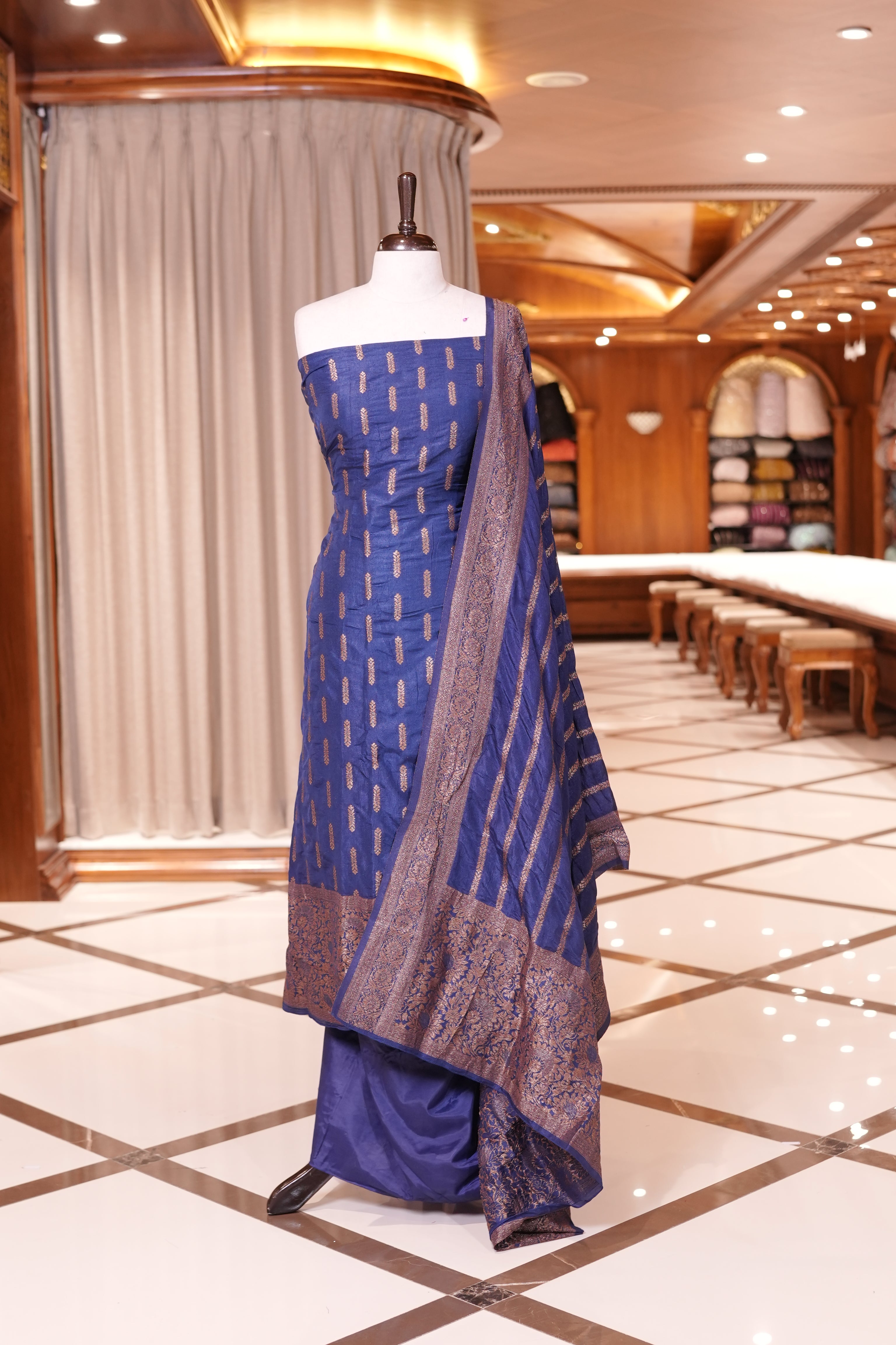 Dark Blue colour Semi Banarasi Silk top adorned with elegant Copper zari patterns and a rich border, paired with a zari worked dupatta and a plain bottom.