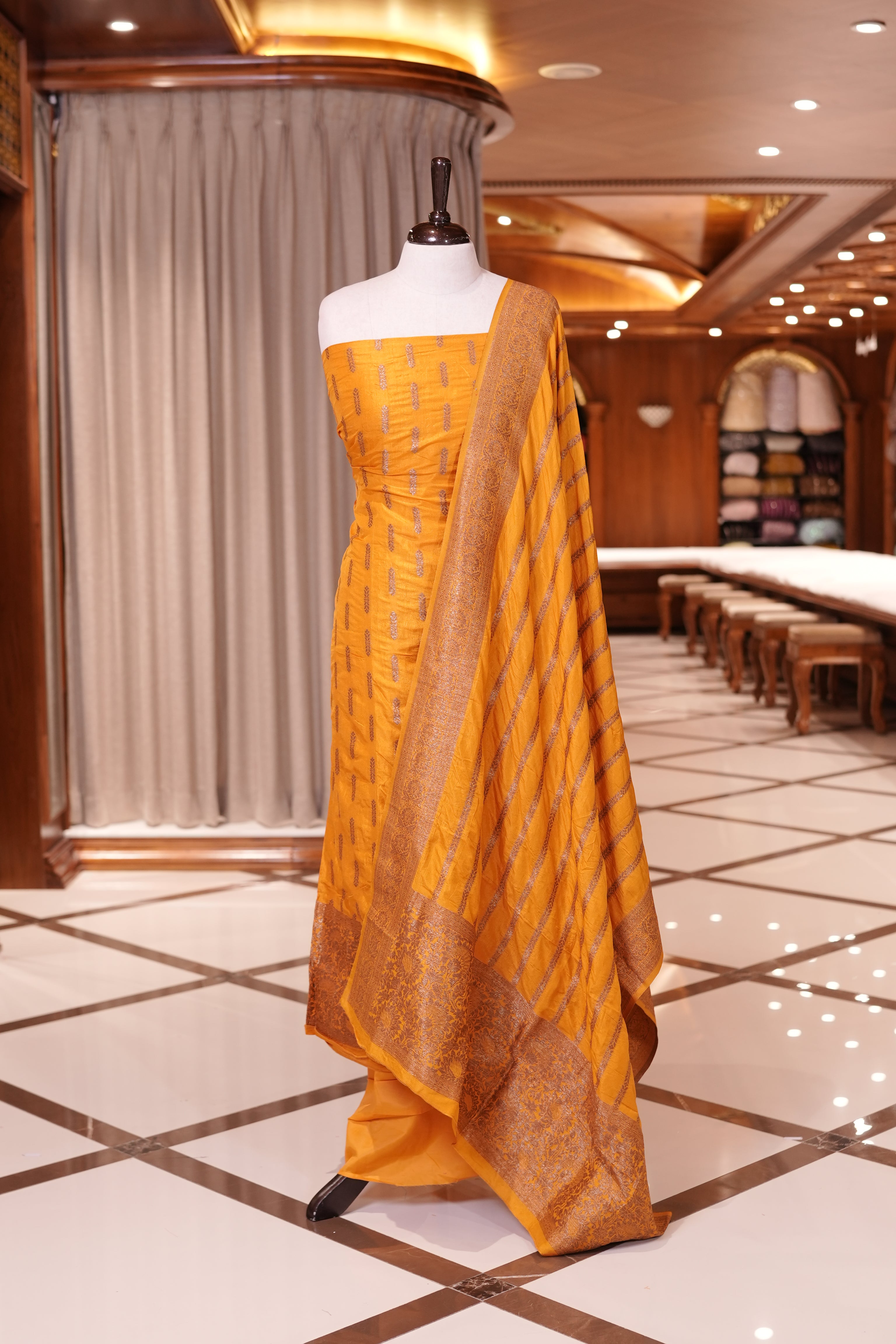 Yellow colour Semi Banarasi Silk top adorned with elegant Copper zari patterns and a rich border, paired with a zari worked dupatta and a plain bottom.