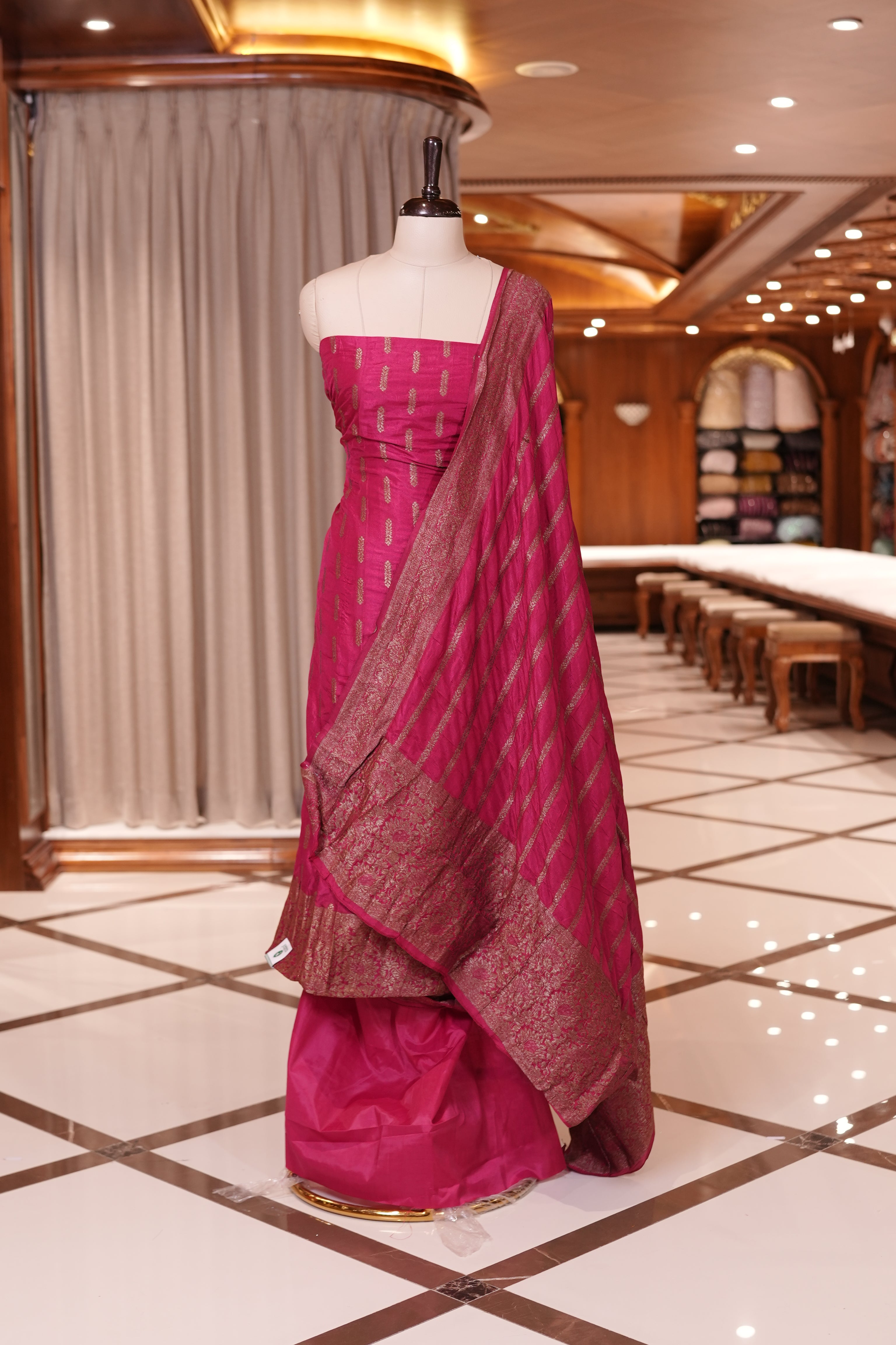Magenta colour Semi Banarasi Silk top adorned with elegant Copper zari patterns and a rich border, paired with a zari worked dupatta and a plain bottom.