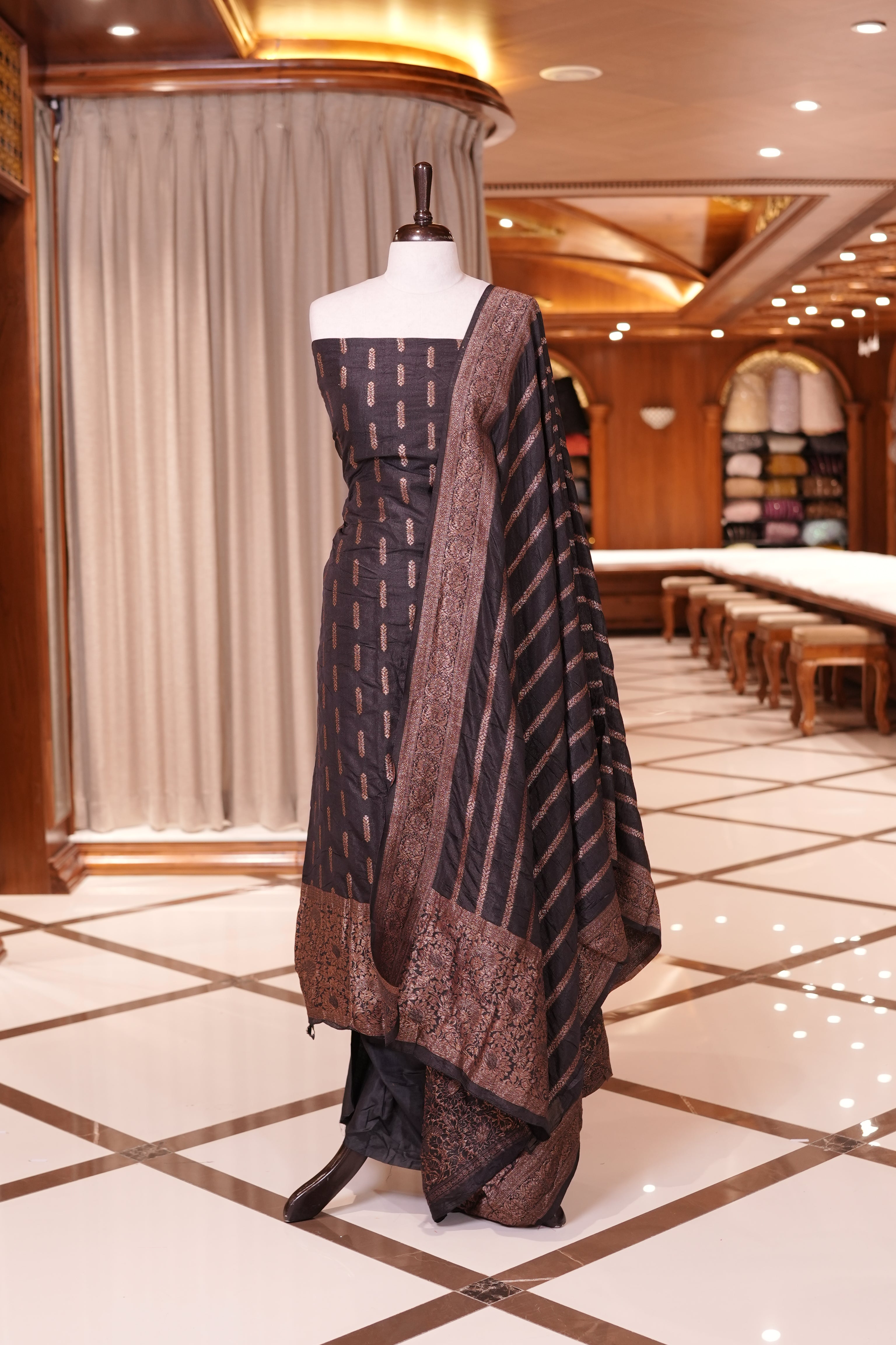 Black colour Semi Banarasi Silk top adorned with elegant Copper zari patterns and a rich border, paired with a zari worked dupatta and a plain bottom.