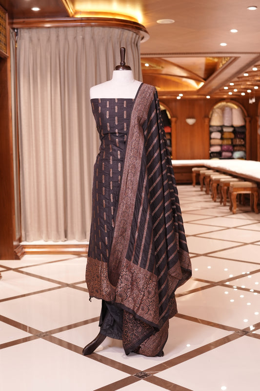 Black colour Semi Banarasi Silk top adorned with elegant Copper zari patterns and a rich border, paired with a zari worked dupatta and a plain bottom.