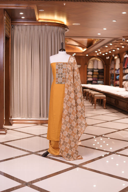 Mustard Yellow colour silk top embellished with elegant geometric patterns and mirror work, paired with a matching designed dupatta and a plain bottom.