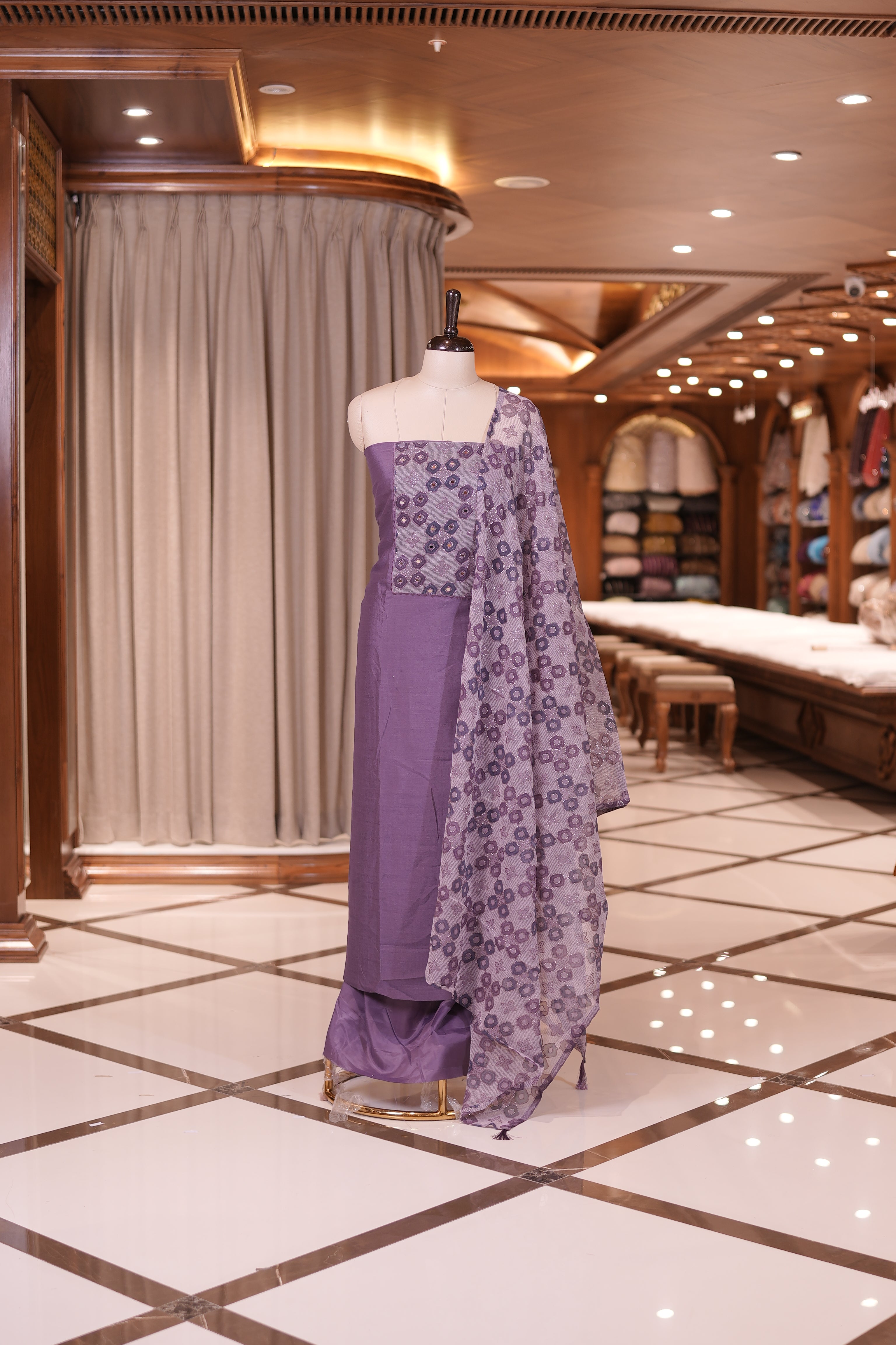 Purple colour silk top embellished with elegant geometric patterns and mirror work, paired with a matching designed dupatta and a plain bottom.