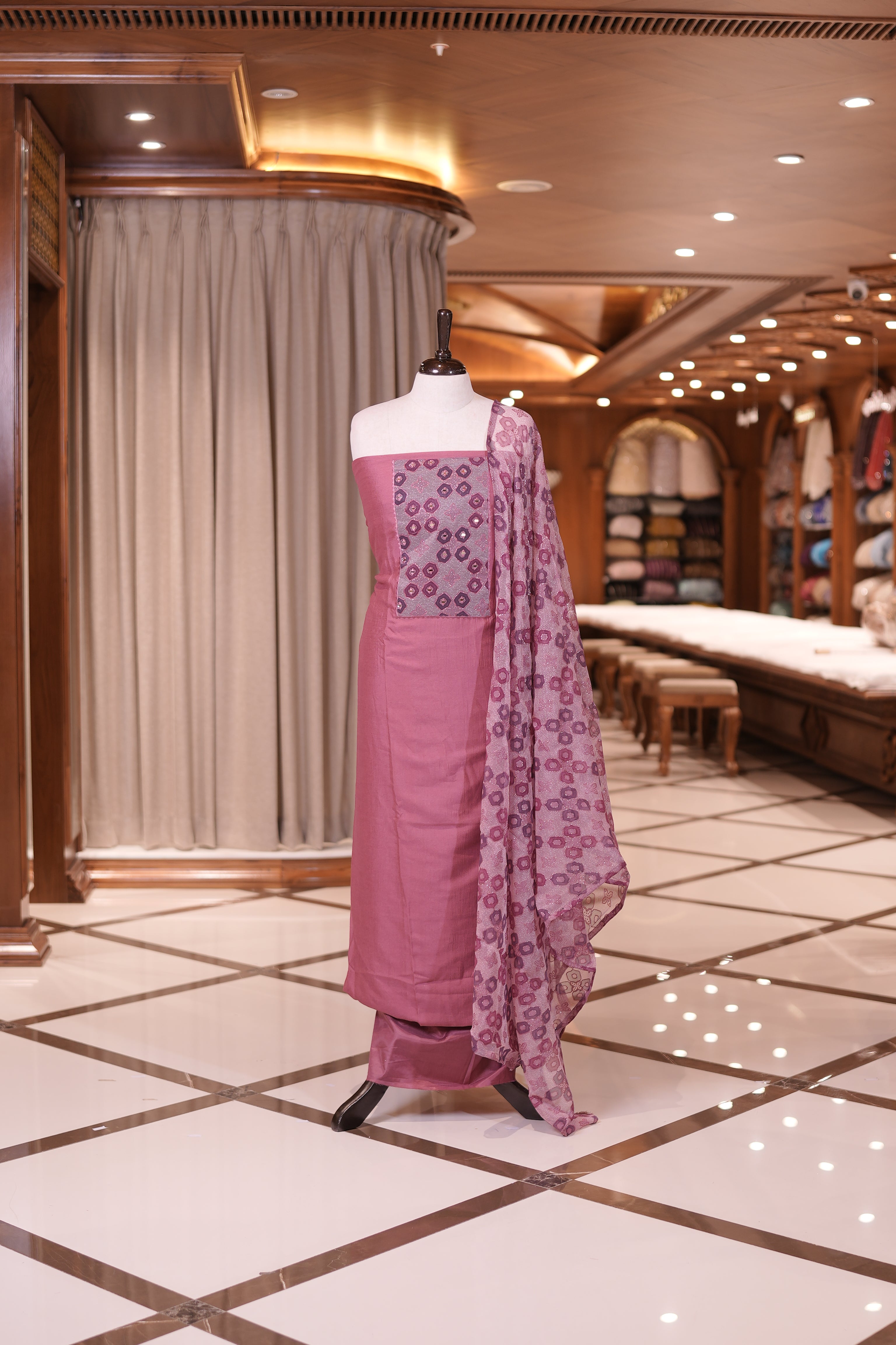 Pink colour silk top embellished with elegant geometric patterns and mirror work, paired with a matching designed dupatta and a plain bottom.