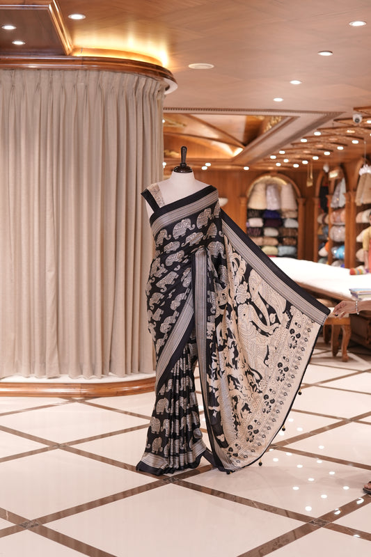 Black & Cream satin modal saree featuring intricate elephant motifs and an artistic pallu, paired with a matching blouse