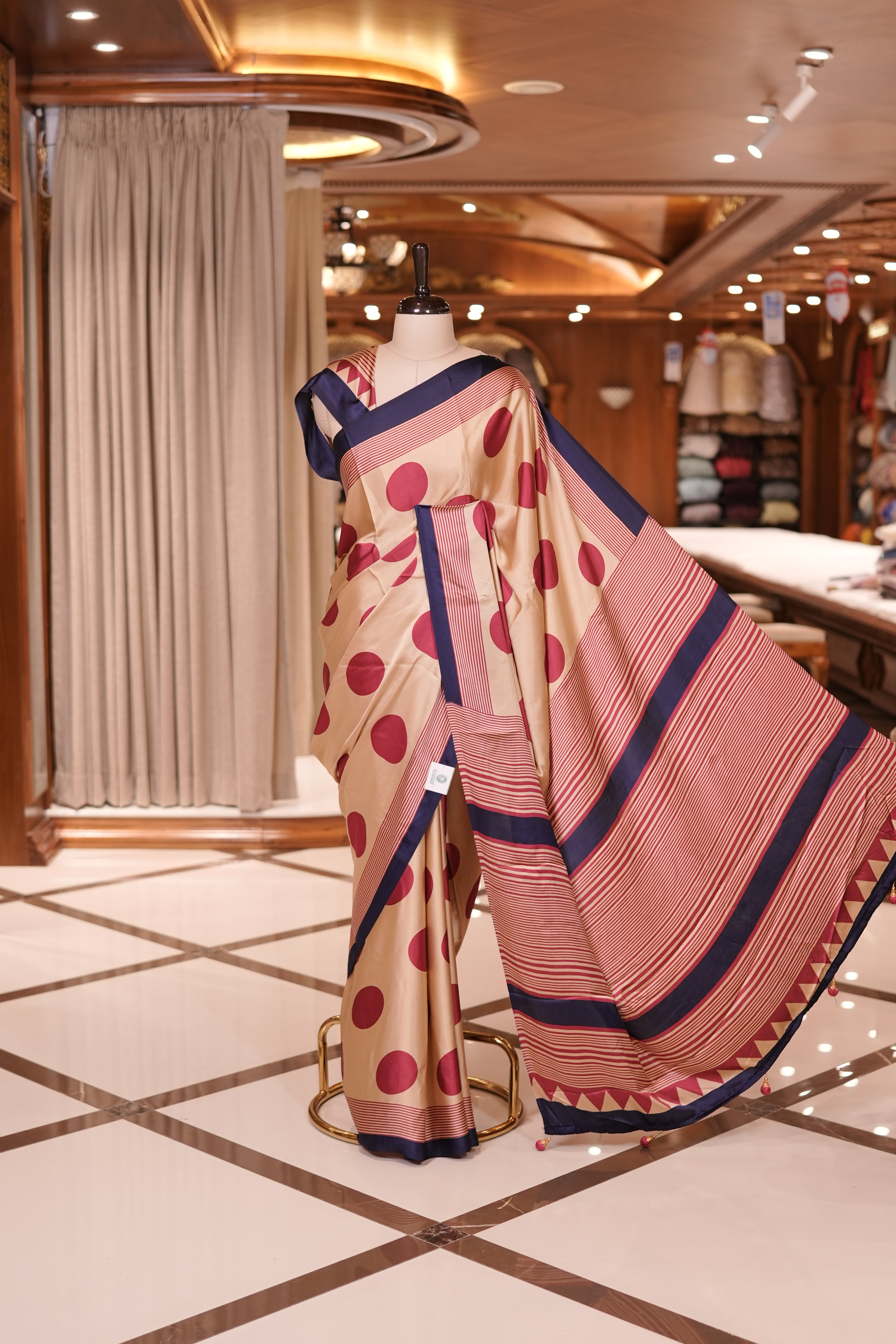 Cream colour semi modal saree featuring bold Red polka dots and elegant striped detailing, finished with a contrasting Purple border and paired with a perfectly matching blouse
