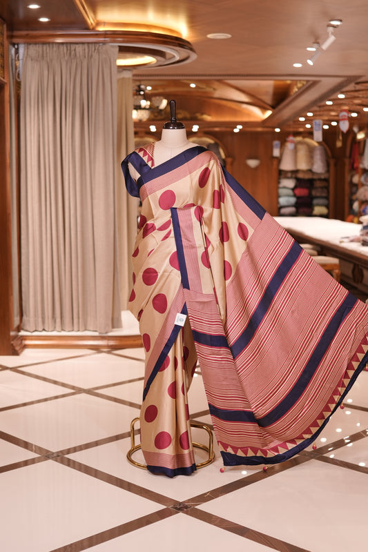 Cream colour semi modal saree featuring bold Red polka dots and elegant striped detailing, finished with a contrasting Purple border and paired with a perfectly matching blouse