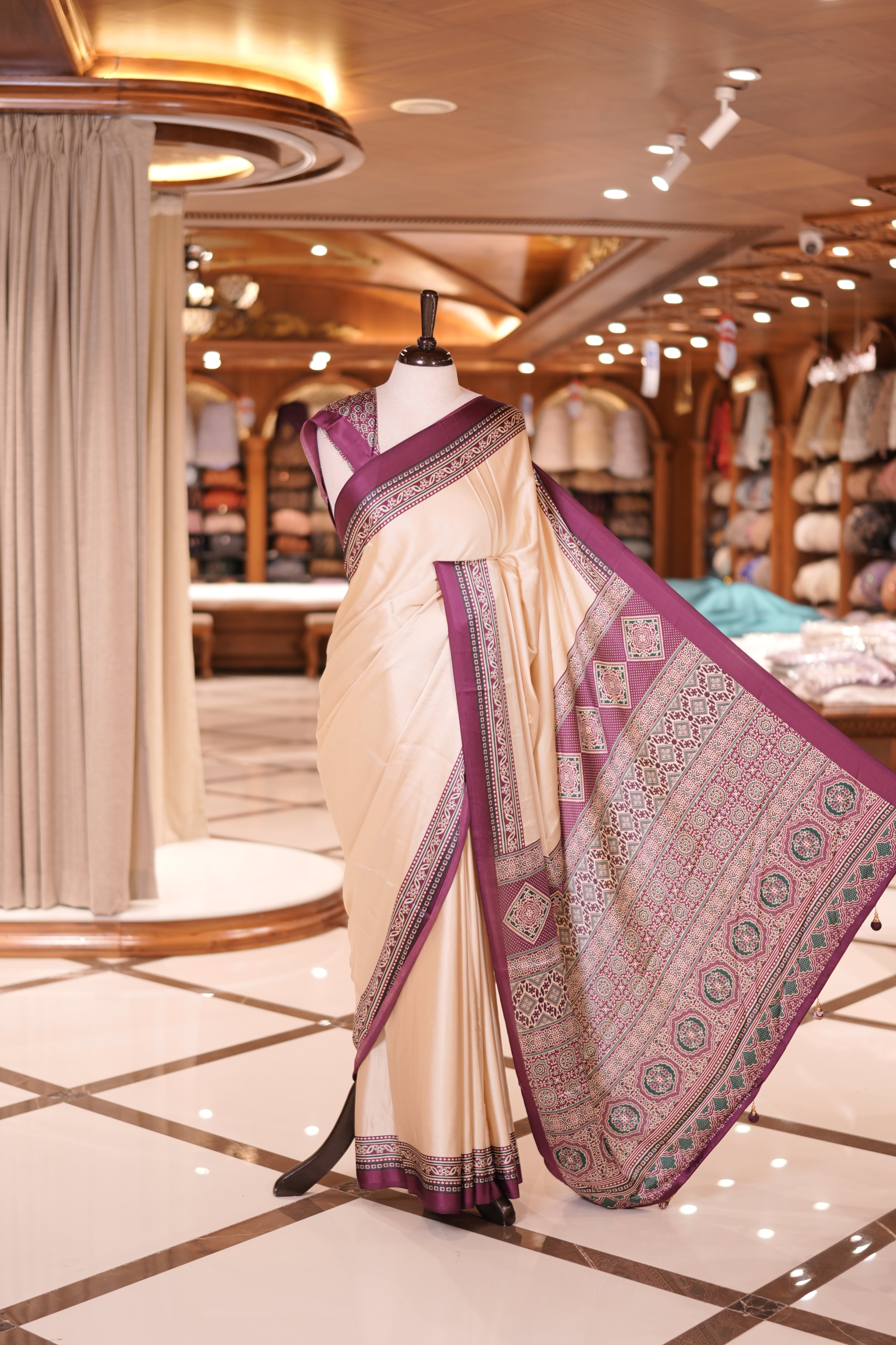 Cream colour semi modal saree featuring an elegant Wine colour border with intricate woven designs and a richly detailed pallu, paired with a matching blouse