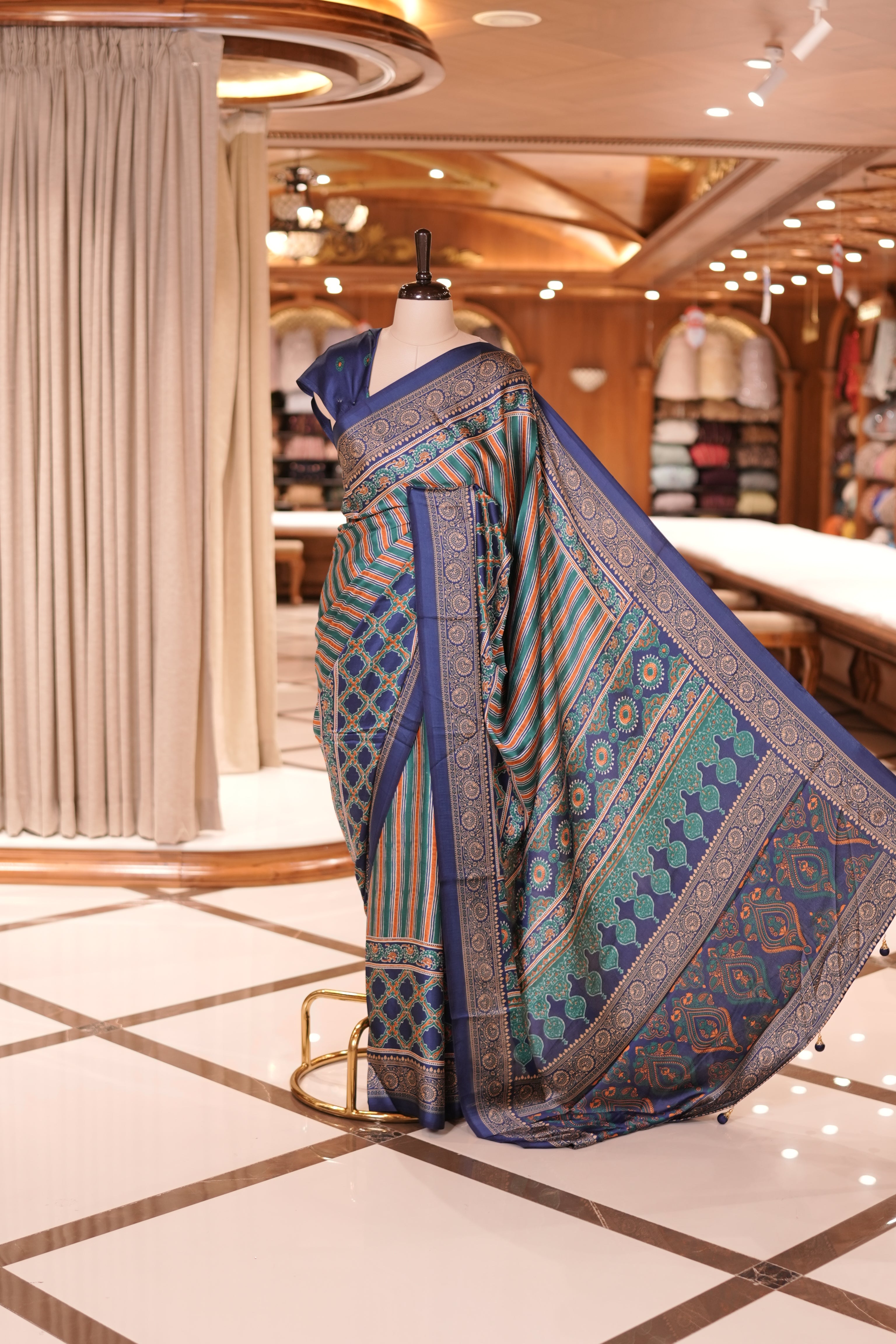 Navy Blue and multi colour semi modal saree featuring vibrant vertical stripes and intricate geometric motifs, beautifully highlighted with an ornate traditional border, and paired with a perfectly matching blouse.