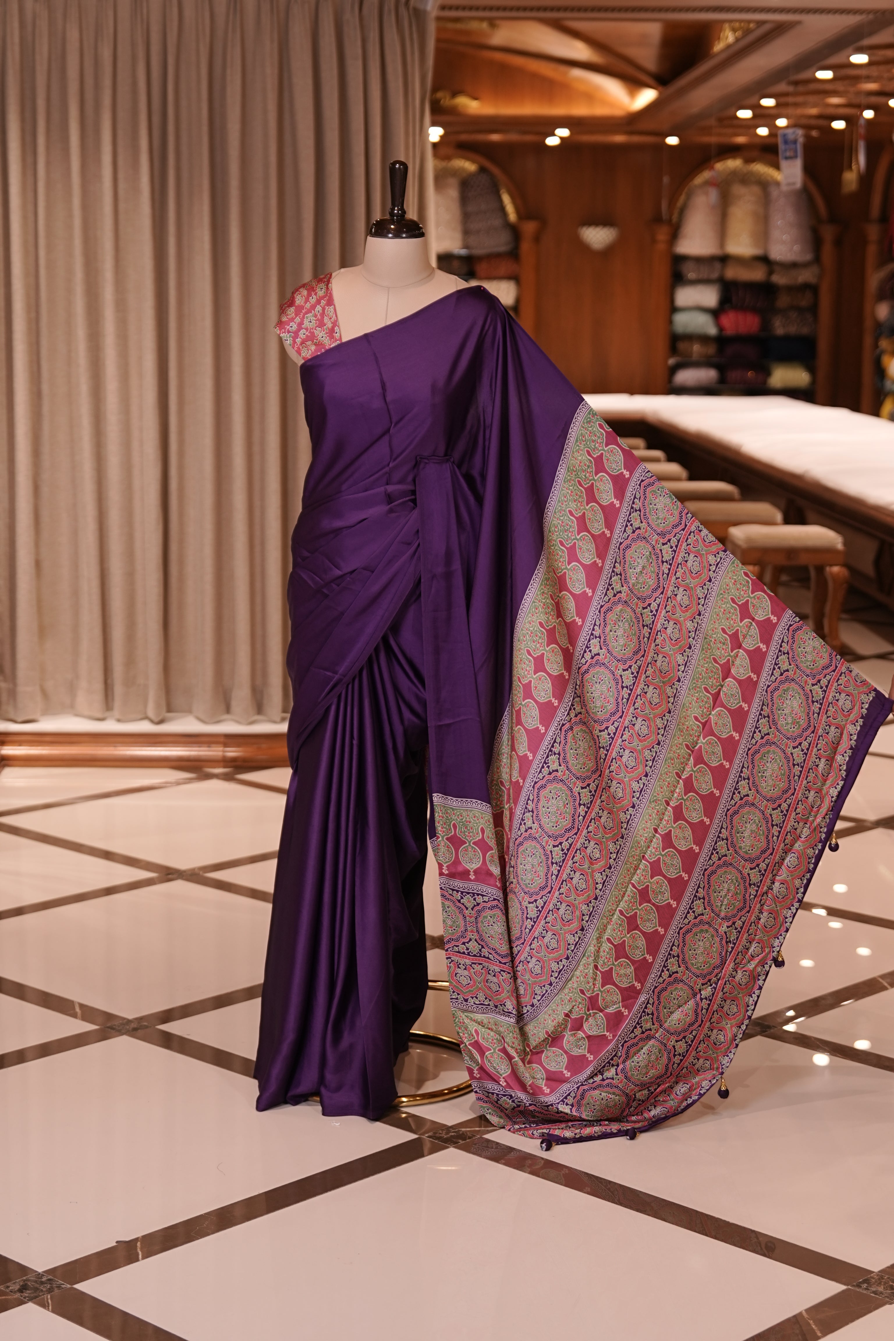 Violet Colour semi modal saree featuring a graceful solid body, beautifully enhanced with an intricately woven contrast Ajrakh printed pallu and a perfectly matching Ajrakh blouse.