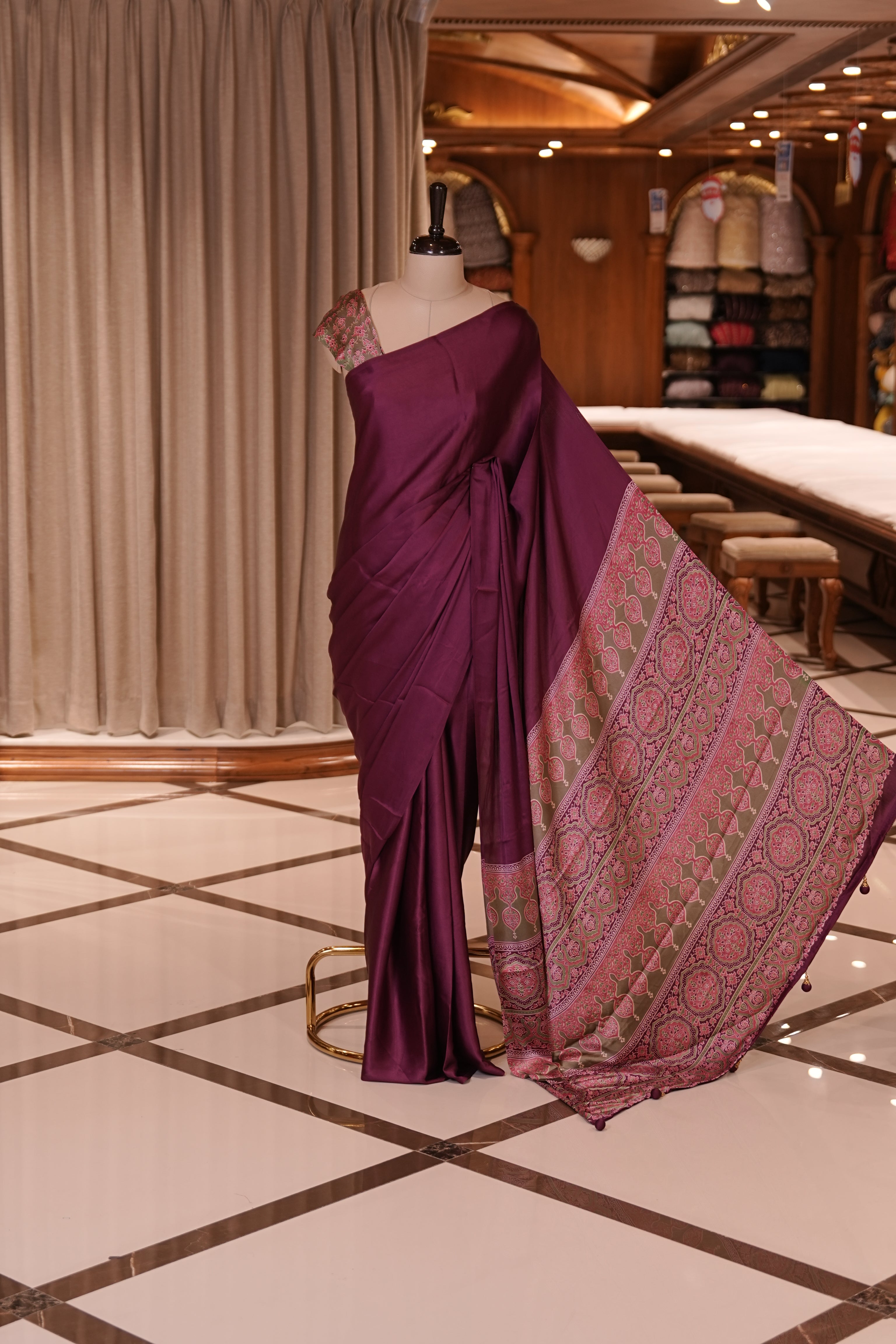 Wine Colour semi modal saree featuring a graceful solid body, beautifully enhanced with an intricately woven contrast Ajrakh printed pallu and a perfectly matching Ajrakh blouse.