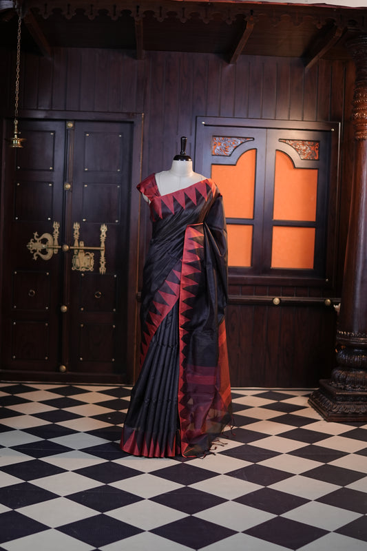 Black colour Net cotta saree featuring a striped body with a contrast colored traditional temple-design border, a striped pallu, and paired with a matching blouse.