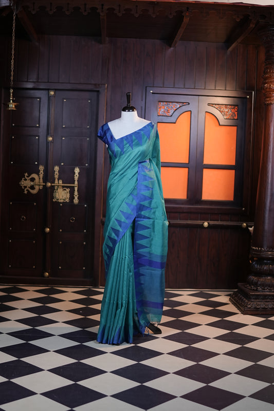 Teal green colour Net cotta saree featuring a striped body with a contrast colored traditional temple-design border, a striped pallu, and paired with a matching blouse.