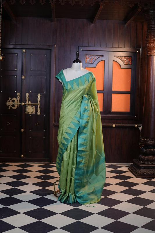 Green colour Net cotta saree featuring a striped body with a contrast colored traditional temple-design border, a striped pallu, and paired with a matching blouse.