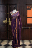 Wine colour mul mul cotton saree accentuated by delicate Gold borders and body, paired with a matching blouse.