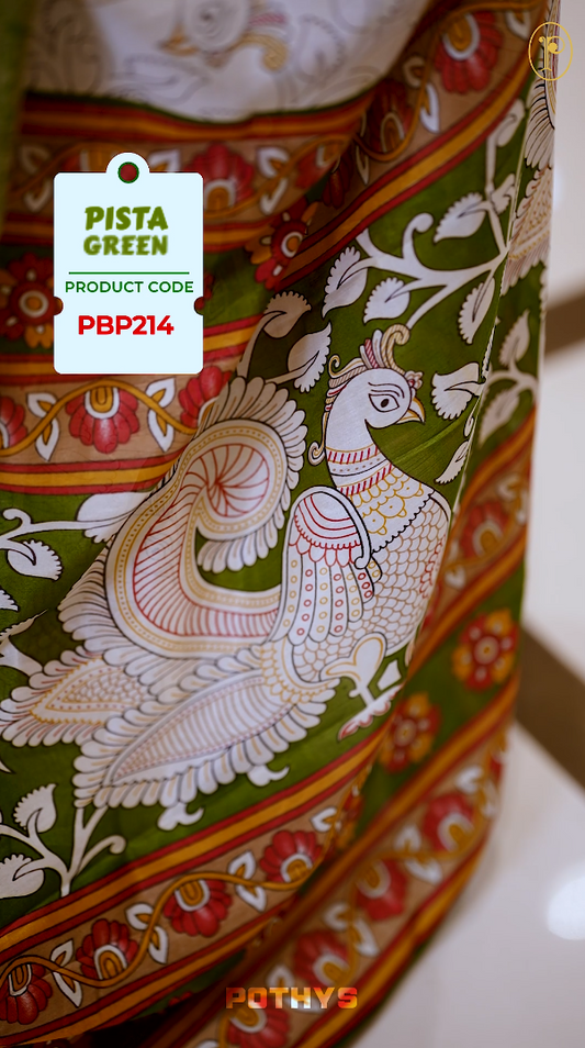 White colour Kalamkari saree featuring intricate prints, paired with a striking pista green and golden traditional border & The multicolor Kalamkari printed pallu adds vibrant charm, perfectly matched with a coordinating blouse.