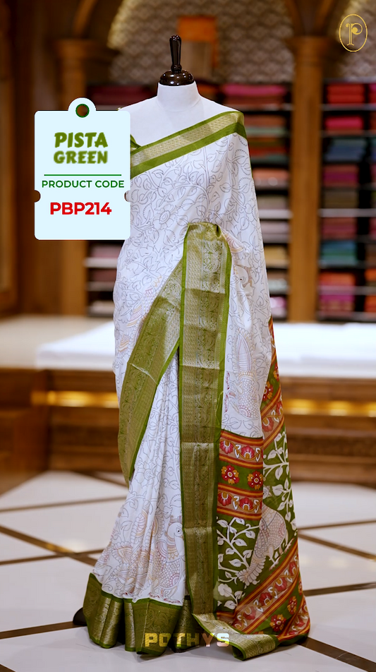 White colour Kalamkari saree featuring intricate prints, paired with a striking pista green and golden traditional border & The multicolor Kalamkari printed pallu adds vibrant charm, perfectly matched with a coordinating blouse.