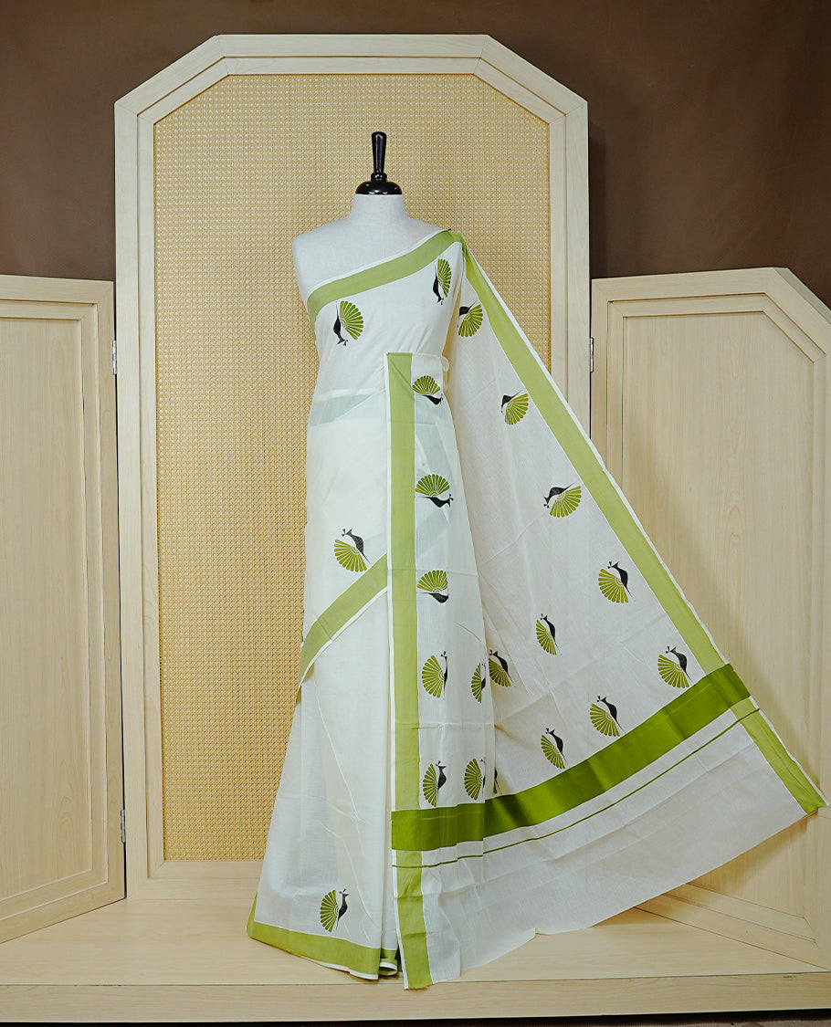Cream colour Cotton Kerala saree Featuring Classy Plain body for Effortless Elegance, enhancing Green with Peacock Printed border, paired with matching blouse piece.