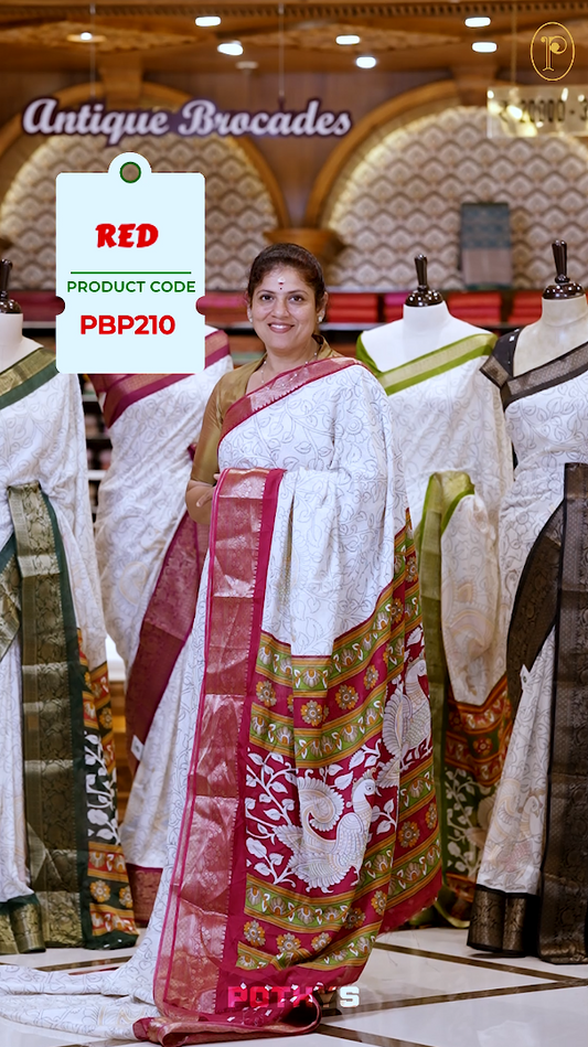 White colour Kalamkari saree featuring intricate prints, paired with a striking red and golden traditional border & The multicolor Kalamkari printed pallu adds vibrant charm, perfectly matched with a coordinating blouse.