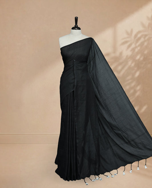Black Colour Mul Cotton saree featuring Elegant plain body, Comes with no border, finished with stylish tassels.