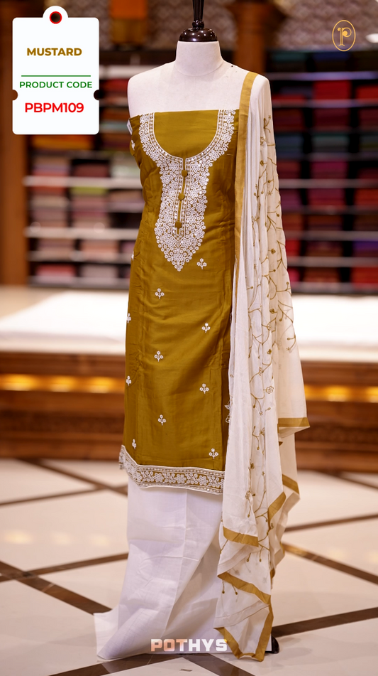 Mustard colour semi silk salwar set highlighted with intricate white chikankari embroidery on the neckline and body, paired with matching bottom and contrasting ivory dupatta.