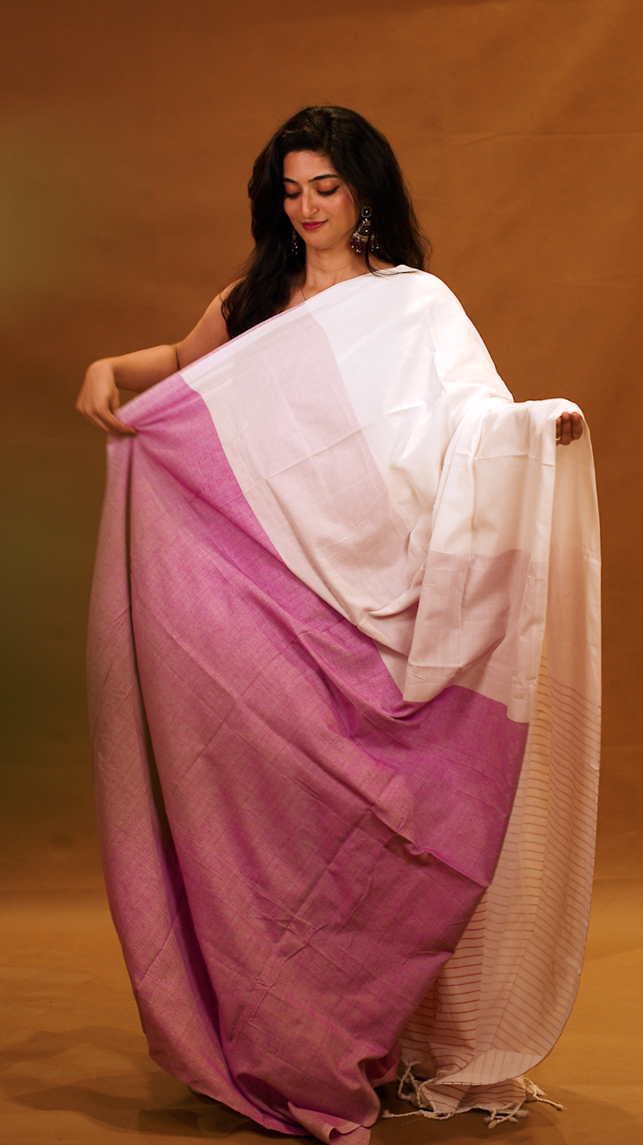 Magenta colour Mul Cotton saree featuring a half and half patterned body, highlighted by a contrast border and striped pallu, paired with a matching blouse piece.