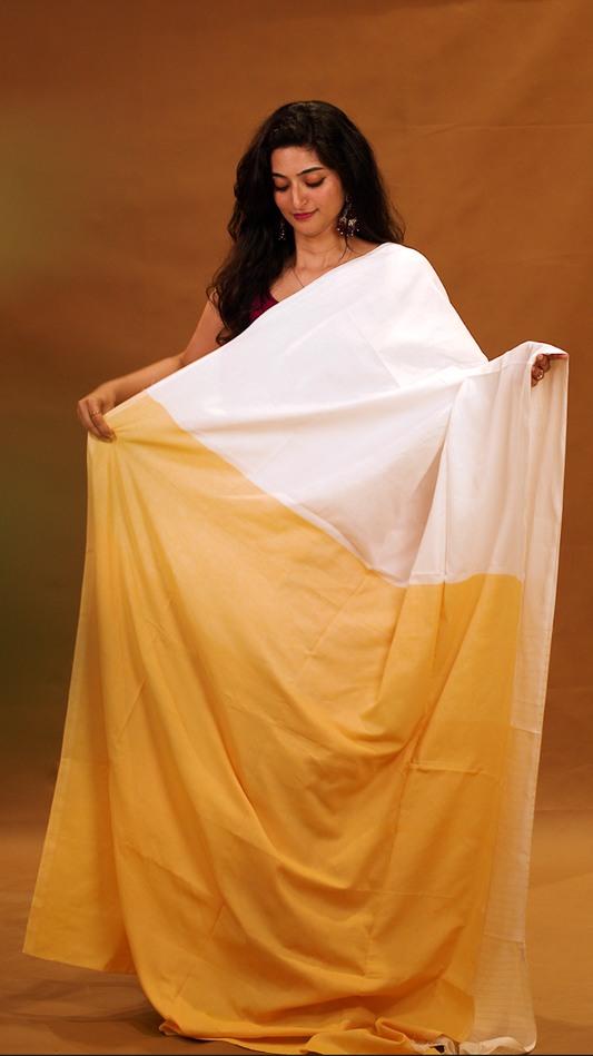Yellow colour Mul Cotton saree featuring a half and half patterned body, highlighted by a contrast border and striped pallu, paired with a matching blouse piece.
