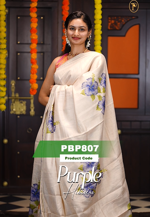 Cream colour soft tissue saree featuring Purple Hibiscus print on body with gold zari outline, kantha stitched detailing border, same print & tassels on pallu, Small floral Print running blouse piece.
