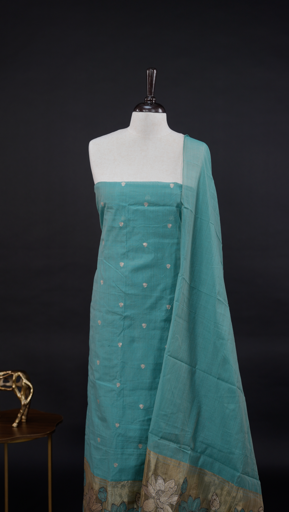Pastel blue Semi chanderi salwar material featuring Gold small Buttas on body, Daman borderi with lotus Design, same pattern dupatta, santoon bottom.