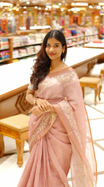 Onion pink colour linen tissue saree featuring Floral design with Aari work & contrast simple border, comes with matching blouse piece.