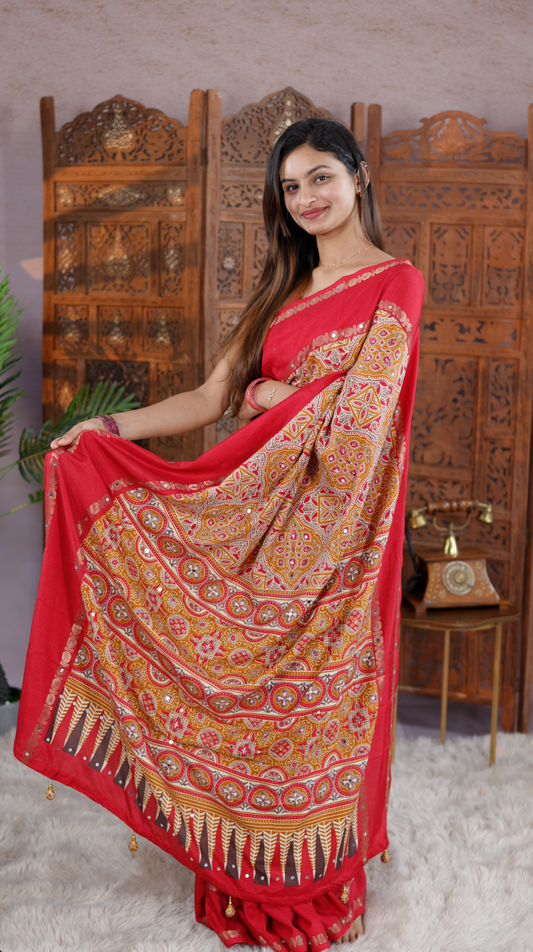 Red Colour Manipuri saree with Ajrakh print with delicate mirror work body, double border, jhumka tassels, matching blouse piece.