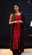 Black colour georgette salwar material featuring floral threadwork, heavy threadwork with sequin detailing on the center, a scalloped dupatta with threadwork, and Shantoon bottom.