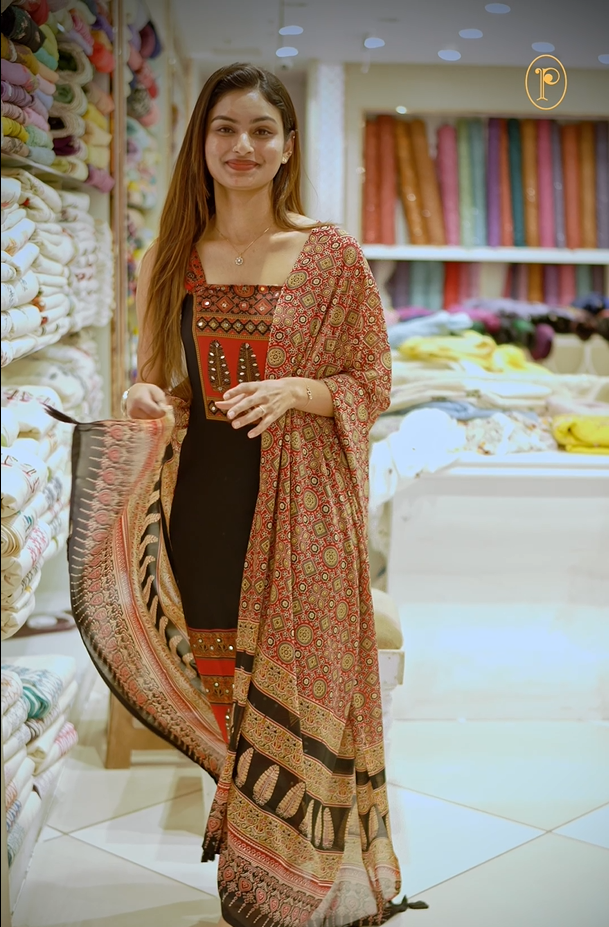 Black colour georgette salwar material featuring Daman Print Detailing Mirror work on neck portion, a dupatta with Same print , and Shantoon bottom.