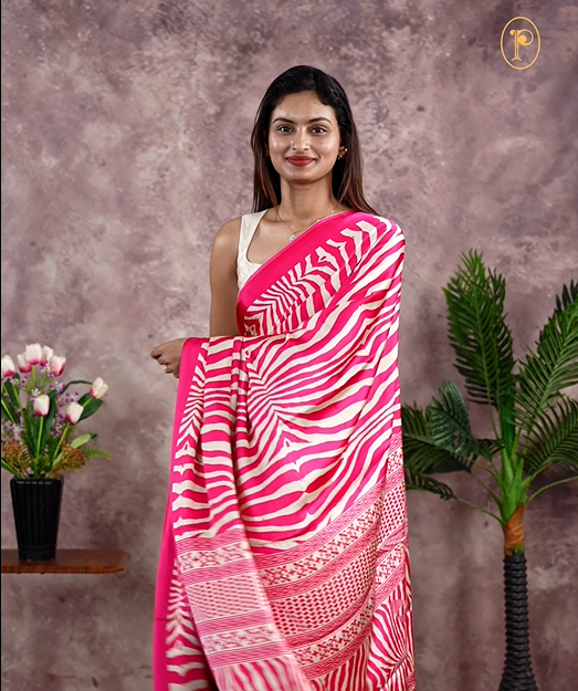 Pink Colour satin model saree featuring Zibra print on body. Ajrak & zibra print on pallu with jhumka tassels, comes with contrast plain blouse piece.